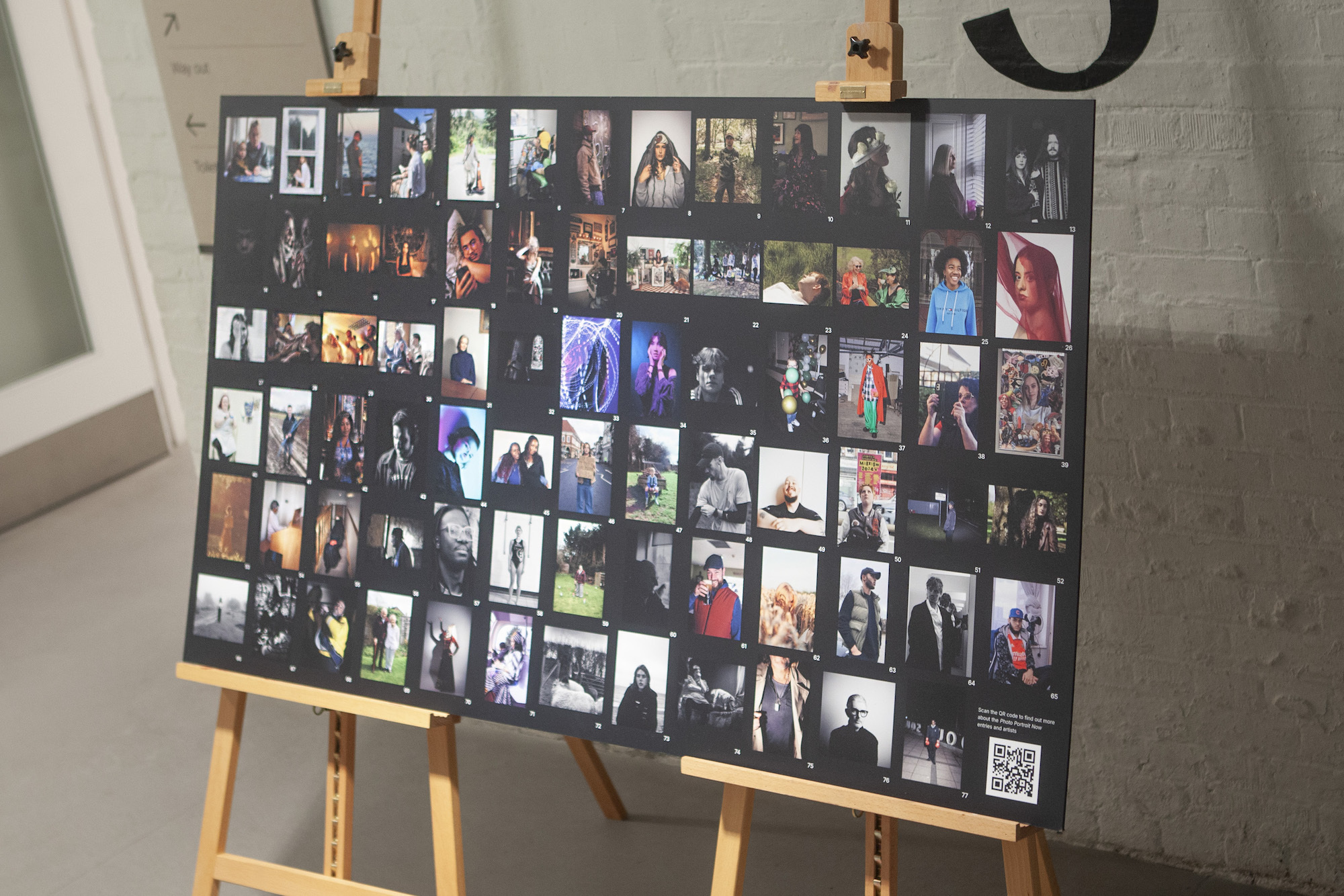 A collection of photography images on a black background, mounted on two wooden easels.