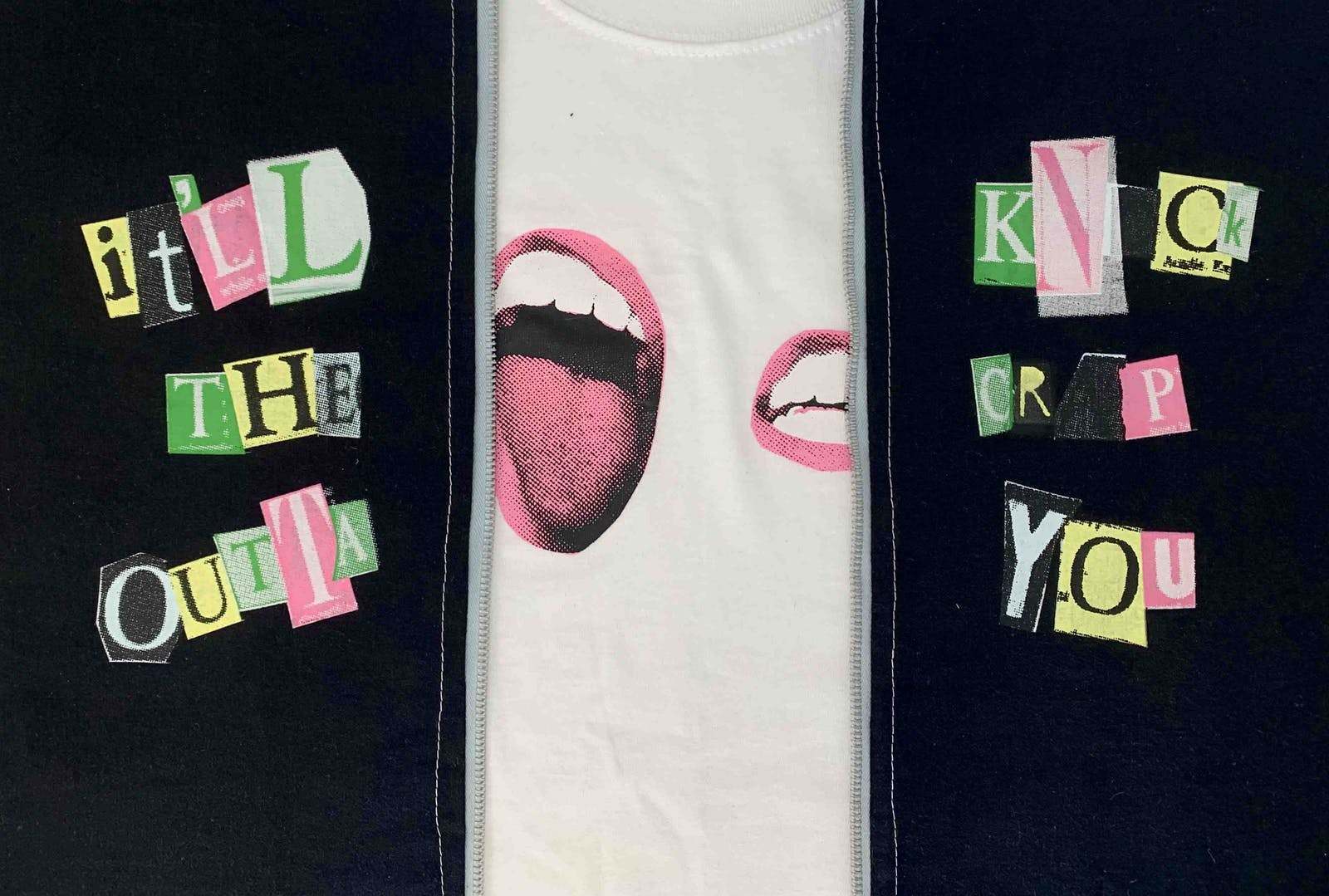 Two sides of a zip-up garment and a T-shirt in the middle. There are two mouths on the T-shirt. The outer garment has text that reads 'It'll knock the crap outta you'.