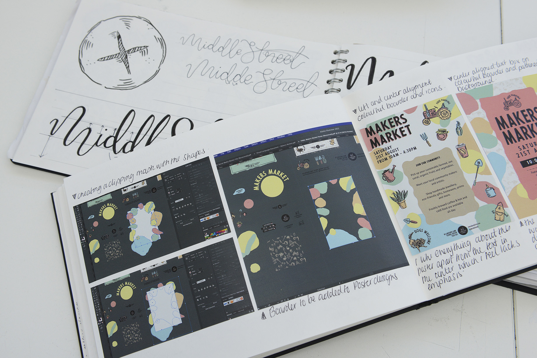 Open portfolio book showing Photoshop screenshots of a creative process on the left-hand page. The portfolio book lies across an open sketchbook showing logo and typography designs.