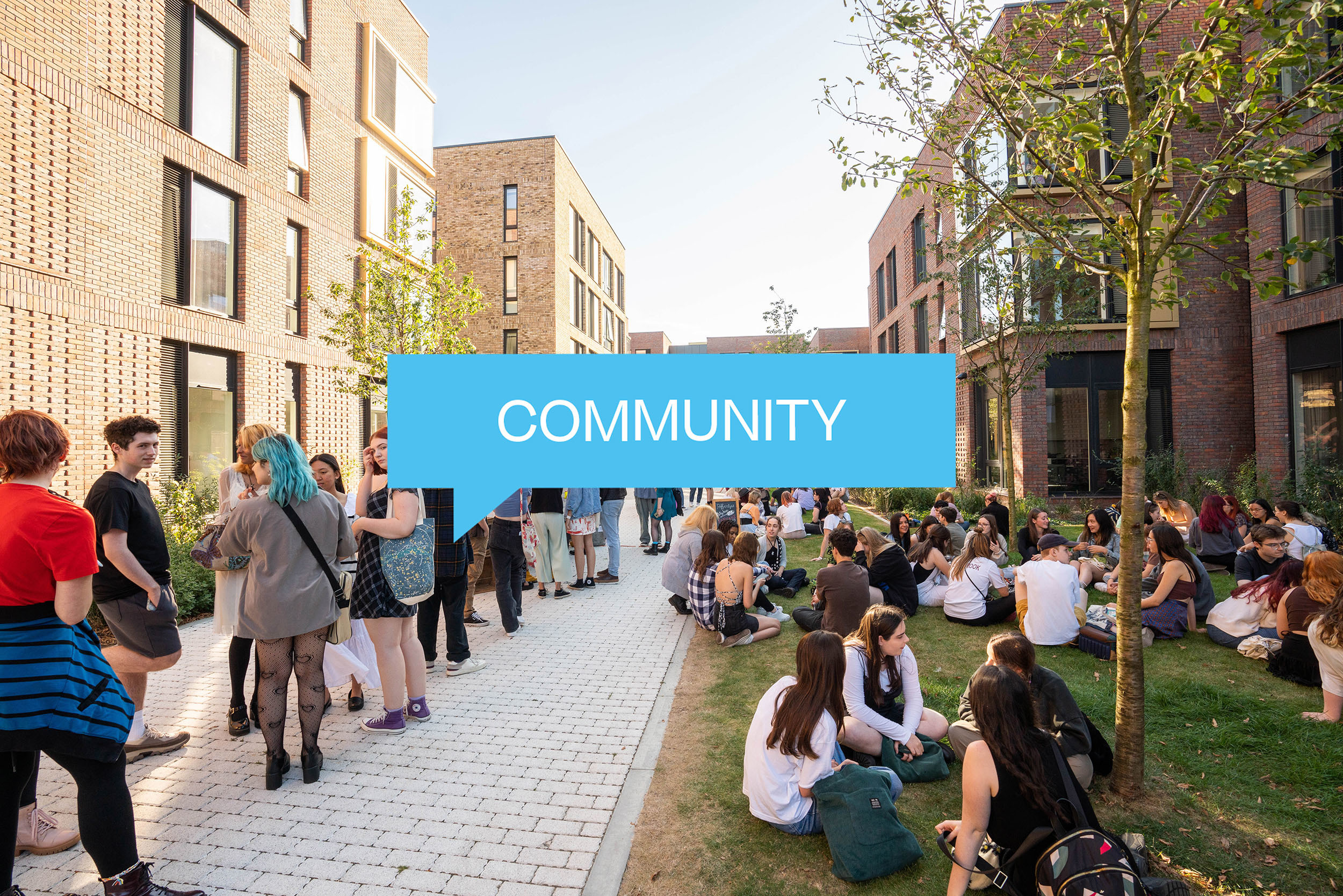 Groups of students mingling outside two university buildings. A speech bubble with the text 'Community' appears in the centre.