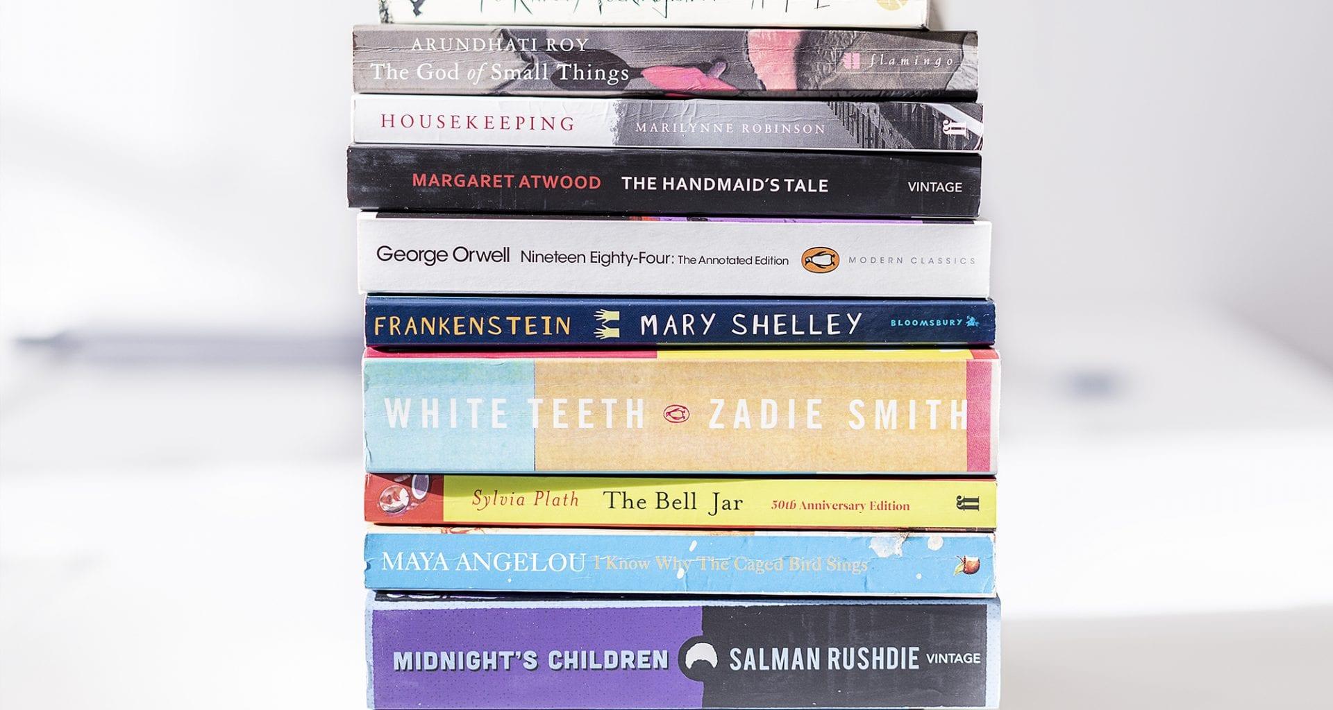 Close-up of a stack of books with their spines and titles facing the front.