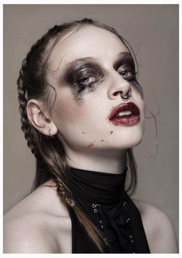 Portrait of a lady with smeared make-up, viewed side-on.