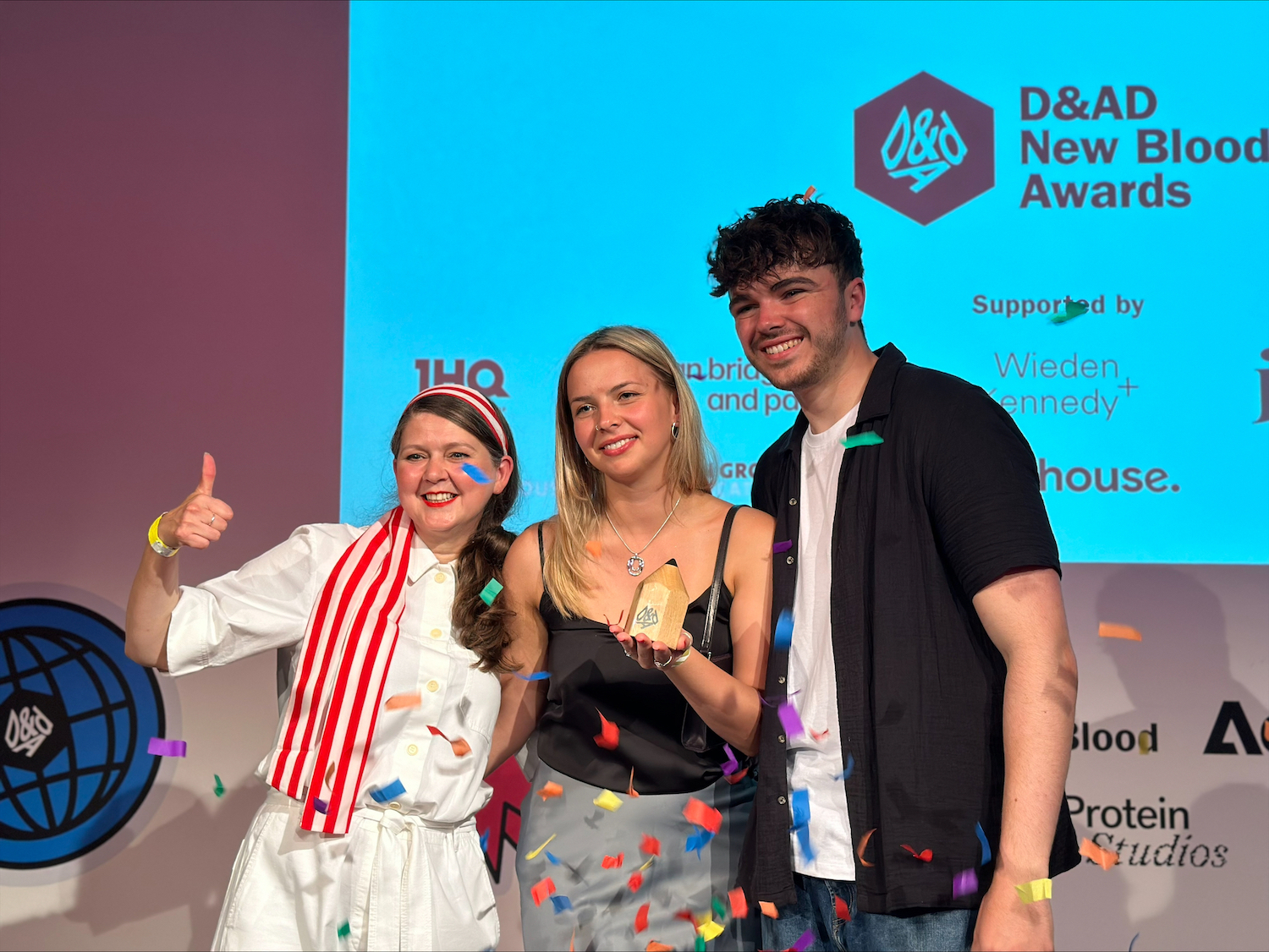 BA (Hons) Graphic Design students G Sarieva and C Wells pose for a photo with the D&AD President at the 2024 D&AD New Blood Awards.