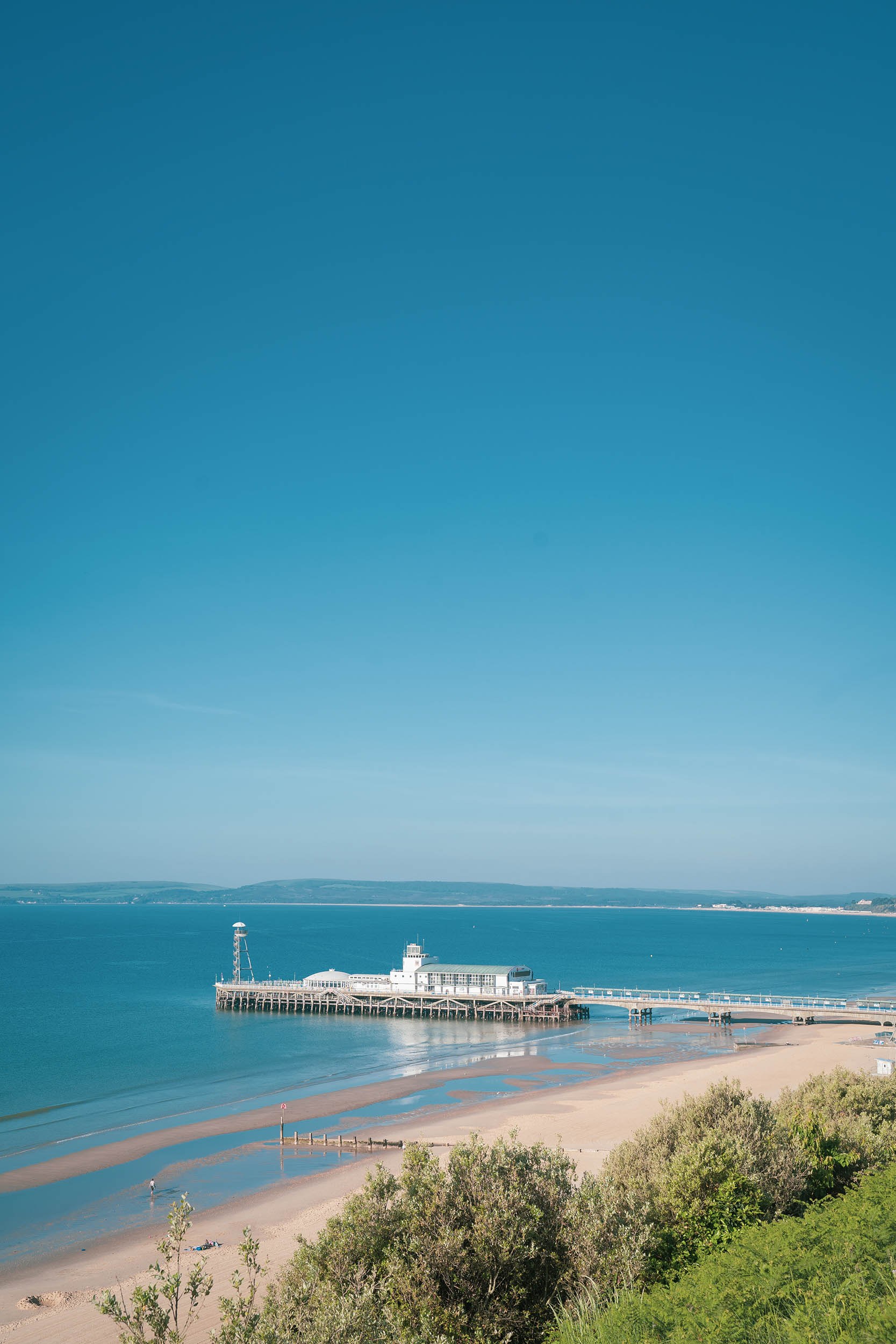 View of Bournemouth Pier jutting out into the sea on a sunny day
