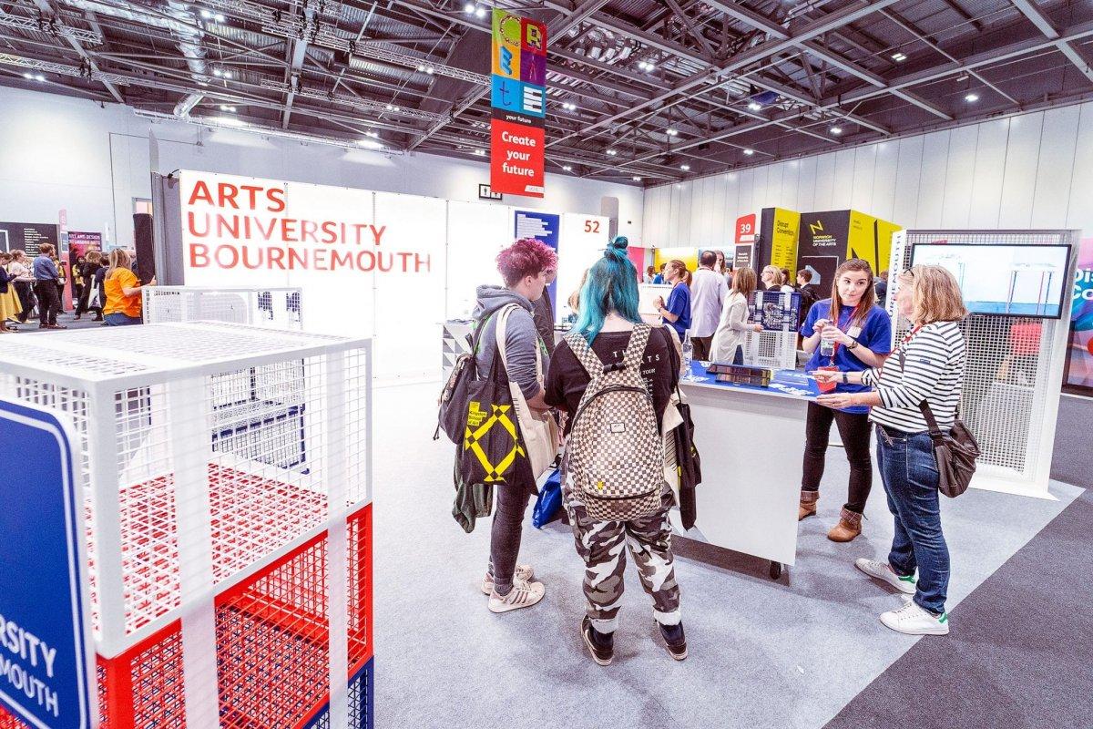 Students speaking to AUB staff at a UCAS event
