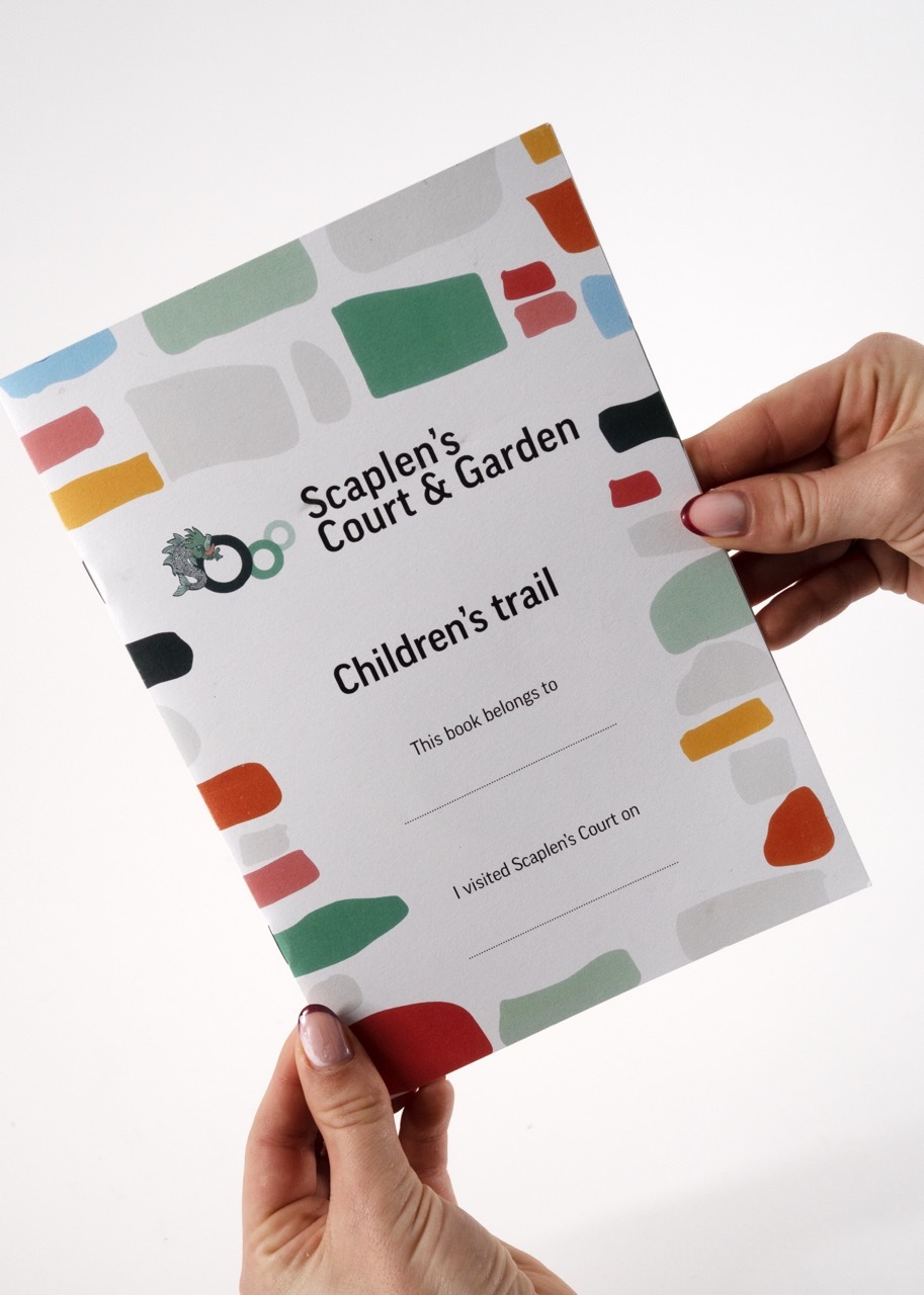Scaplen's Court Children's Trail booklet front cover with colourful bricks.