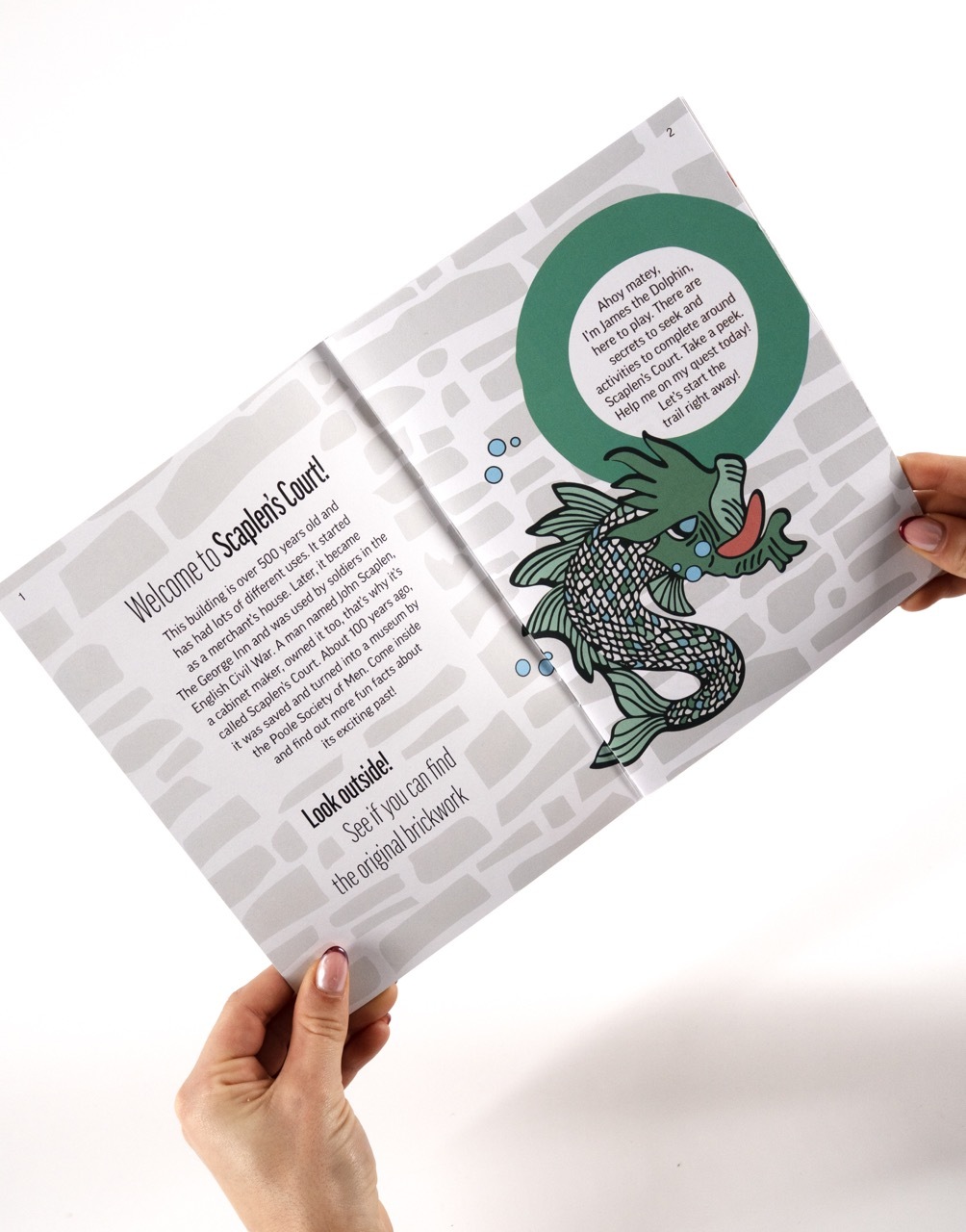 Scaplen's Court Children's Trail booklet, two-page spread with intro paragraph and illustrated green fish-like character.