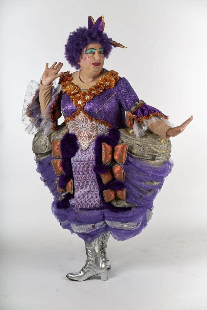 Person in pantomime dame-style costume poses for a photo.