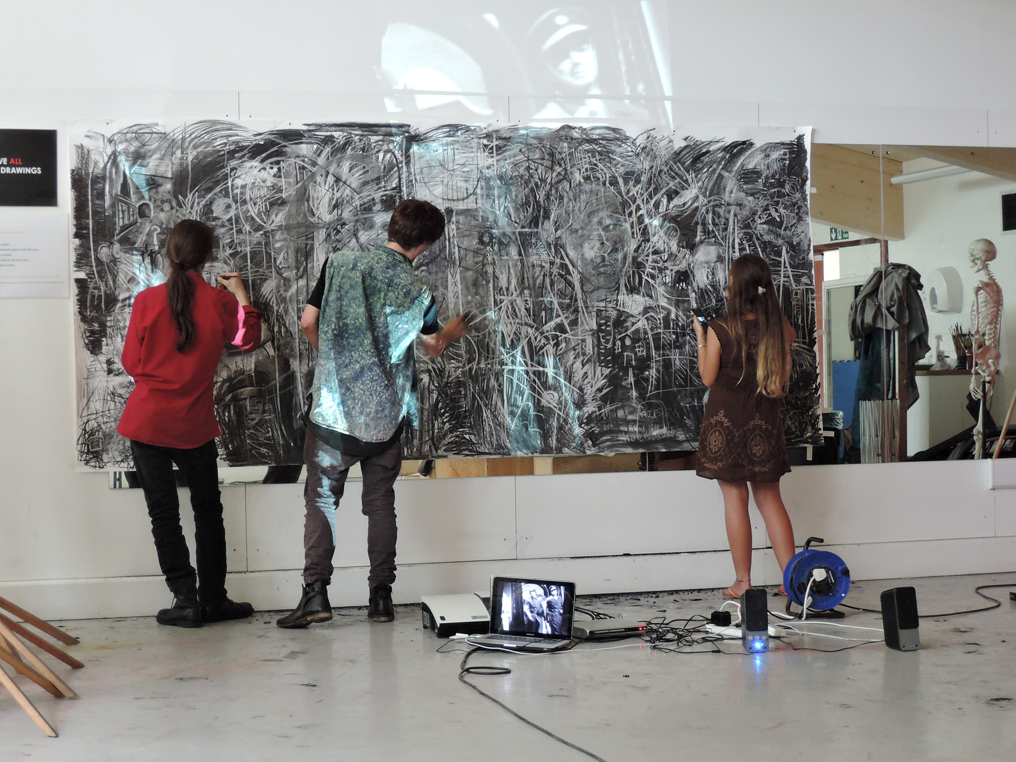 Students working on a large abstract wall painting