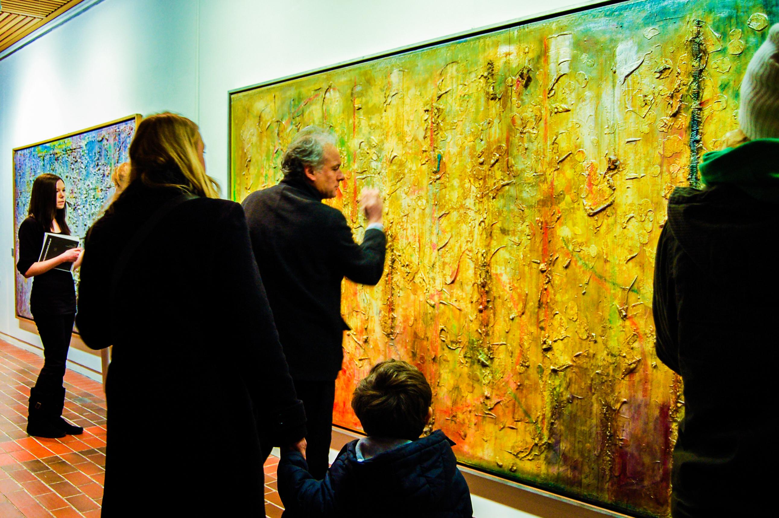 Visitors explore the Frank Bowling: Big Paintings exhibition at AUB.
