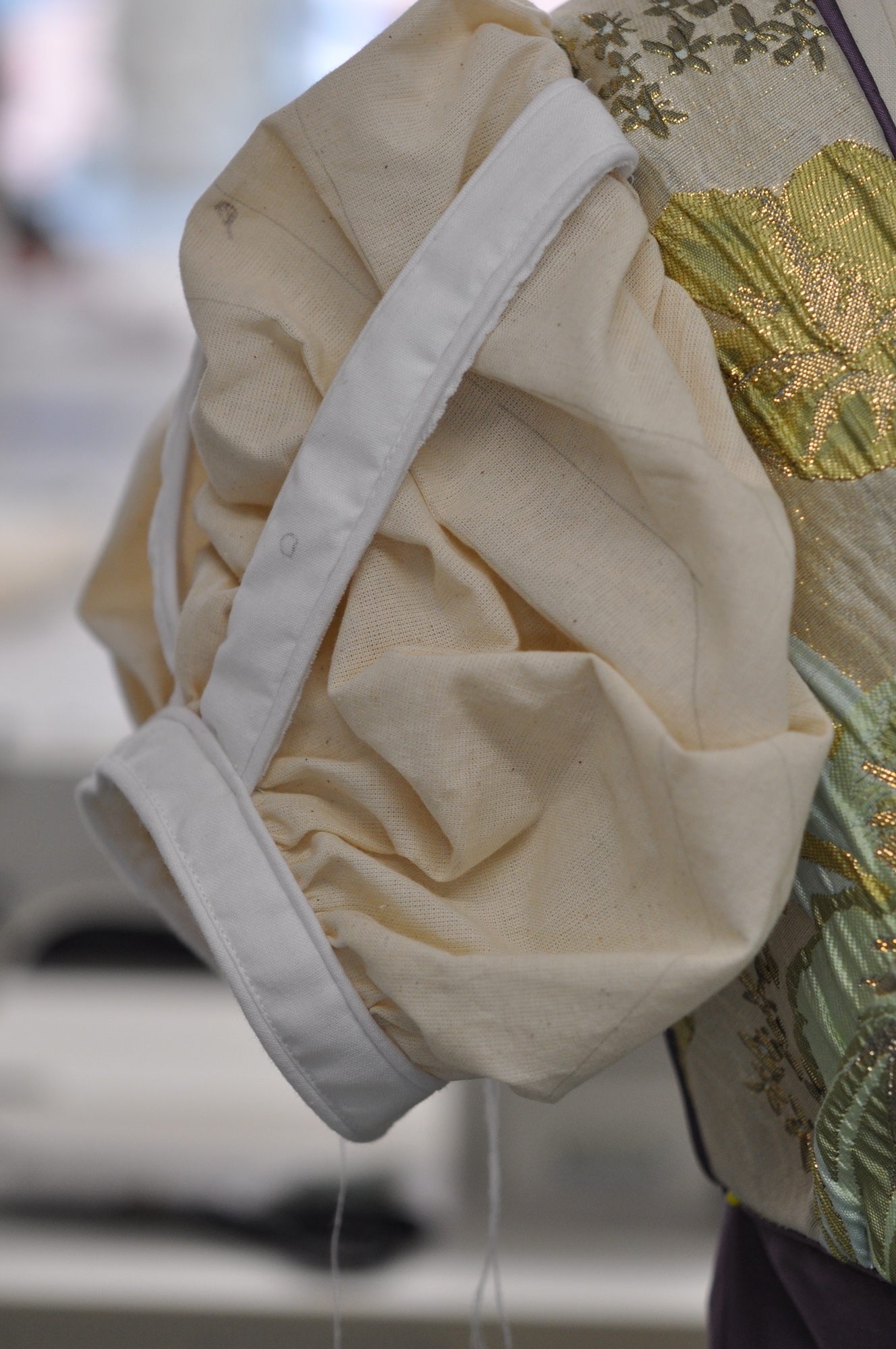 Close-up of a sleeve of a Regency-style dress.
