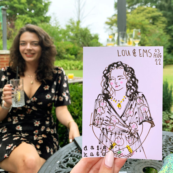 Woman with dark hair in floral dress holds purple illustrated portrait showing curly-haired figure with yellow necklace, dated 03 Aug 16.