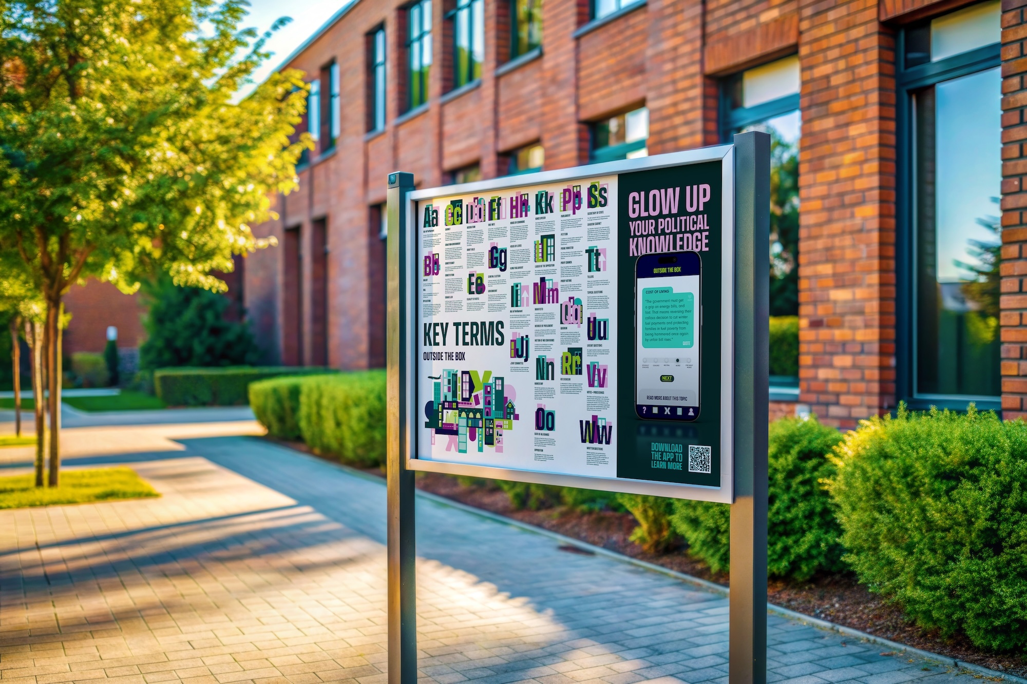 Information board on metal posts outside red brick building with green hedges and trees along paved walkway.
