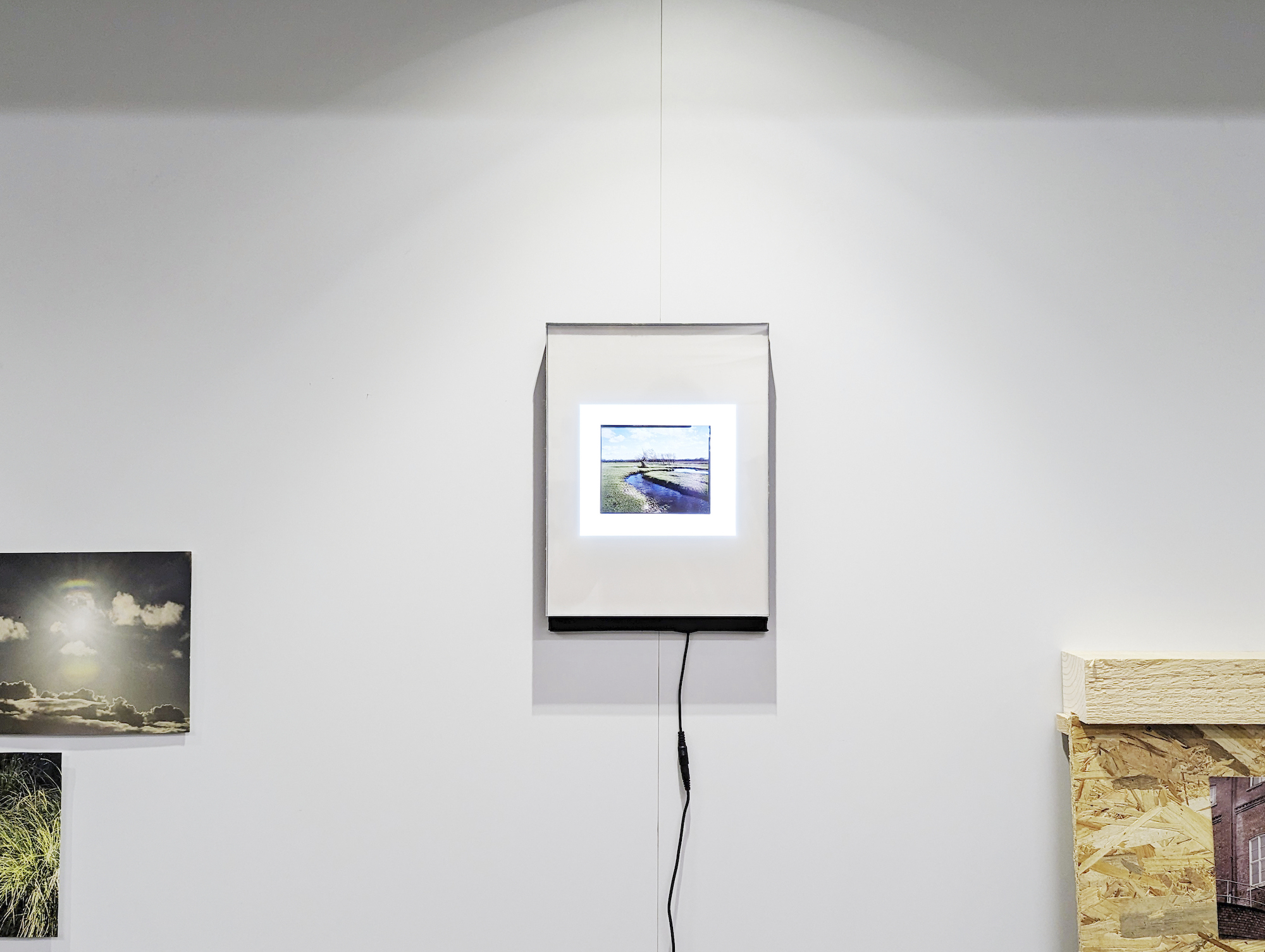 A single film photograph in a frame on a gallery wall.
