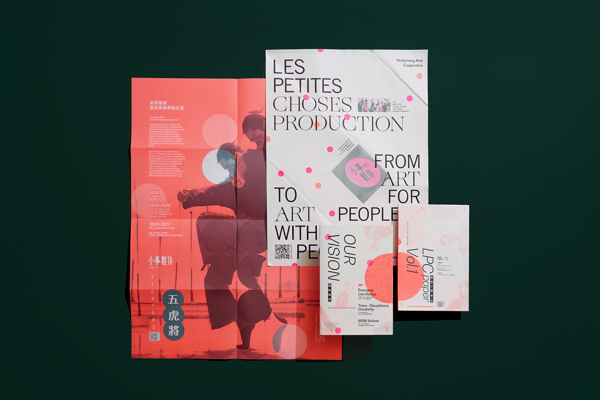 Two posters and two envelopes laid out on a plain surface.