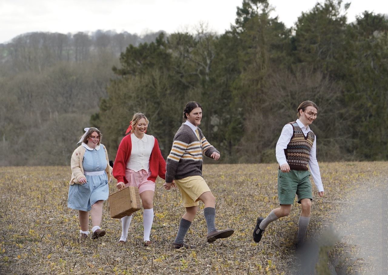 On set photograph from grad film ‘Four Have a Jolly Good Time’ featuring adult actors dressed as children from the 1940s.