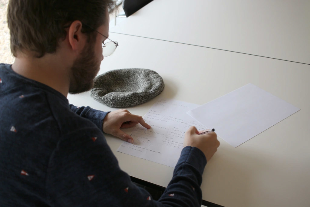 A man writing during a Writing Dis'stories session.