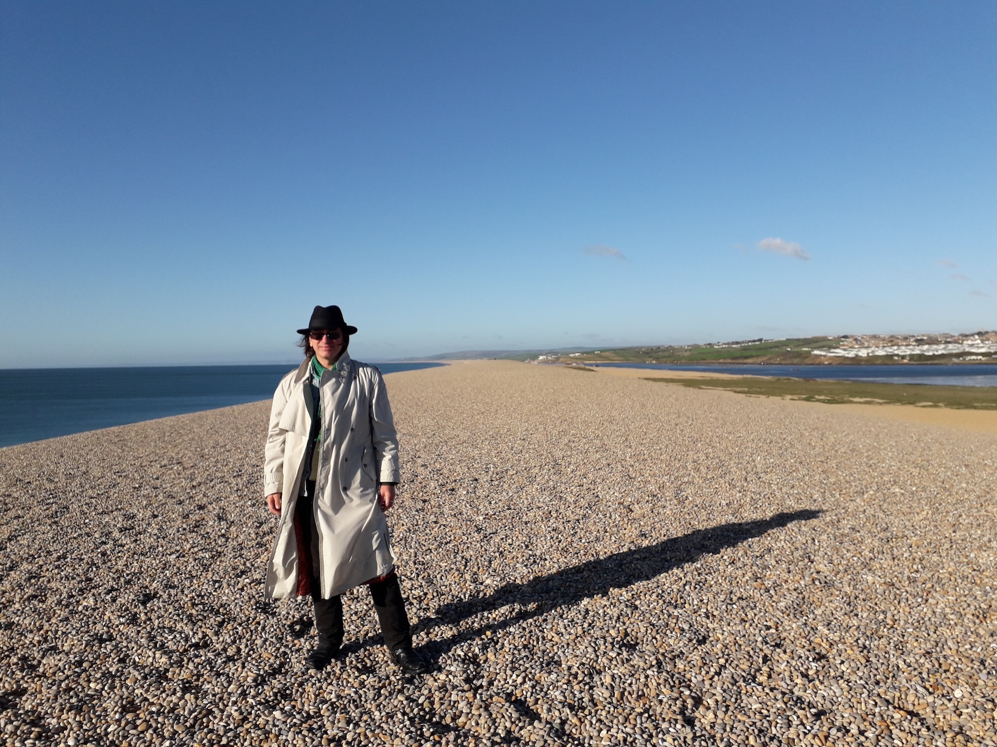 Dr K Manwaring with a wide expanse of Dorset beach surrounding him.