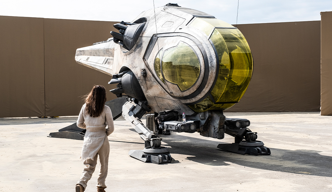 A crew member approaching a vehicle made by BGI Supplies for "Dune: Part Two".