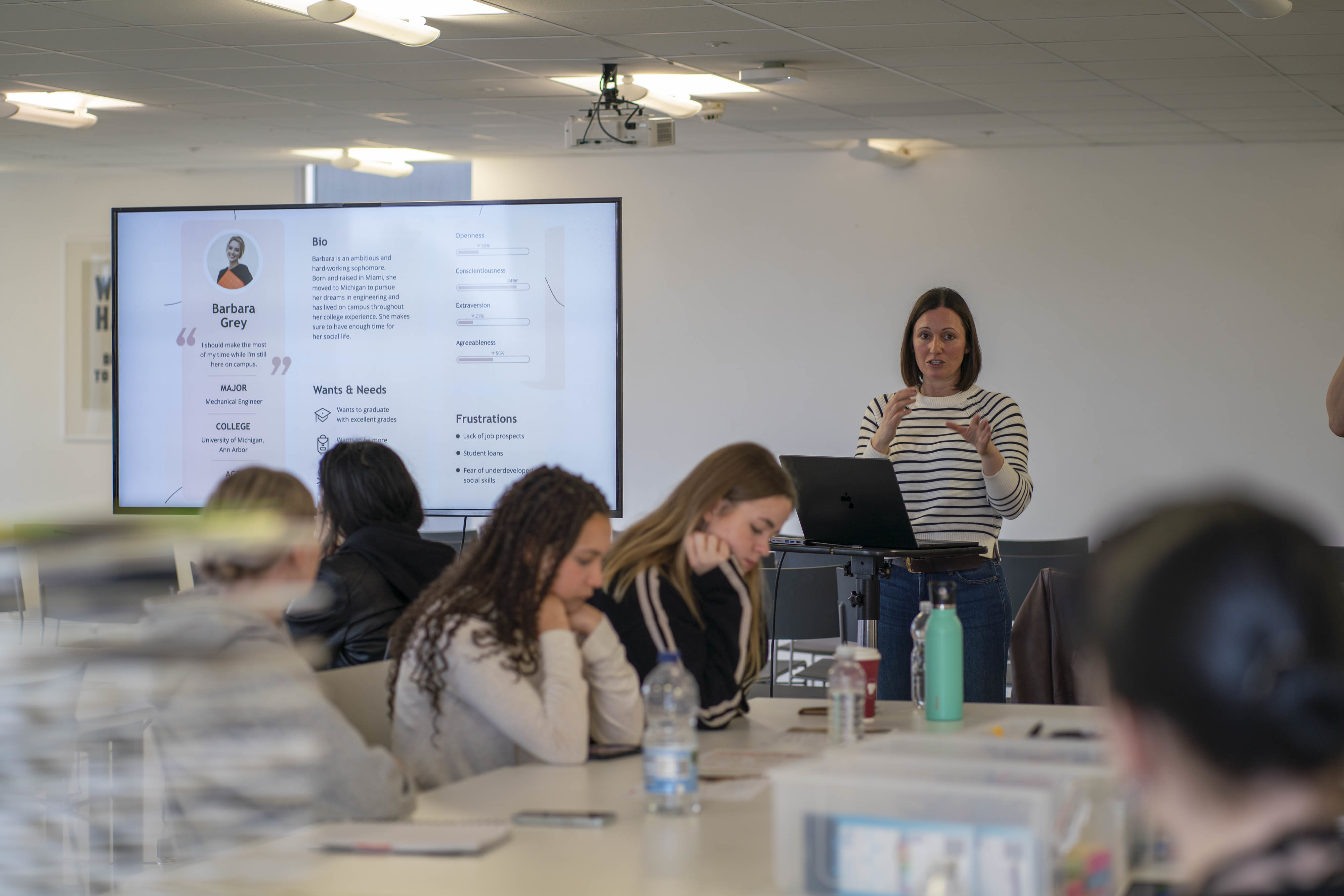 EPM Agency Head of Digital F Griffiths leading a workshop in a seminar room at AUB with BA (Hons) Visual Communication students.