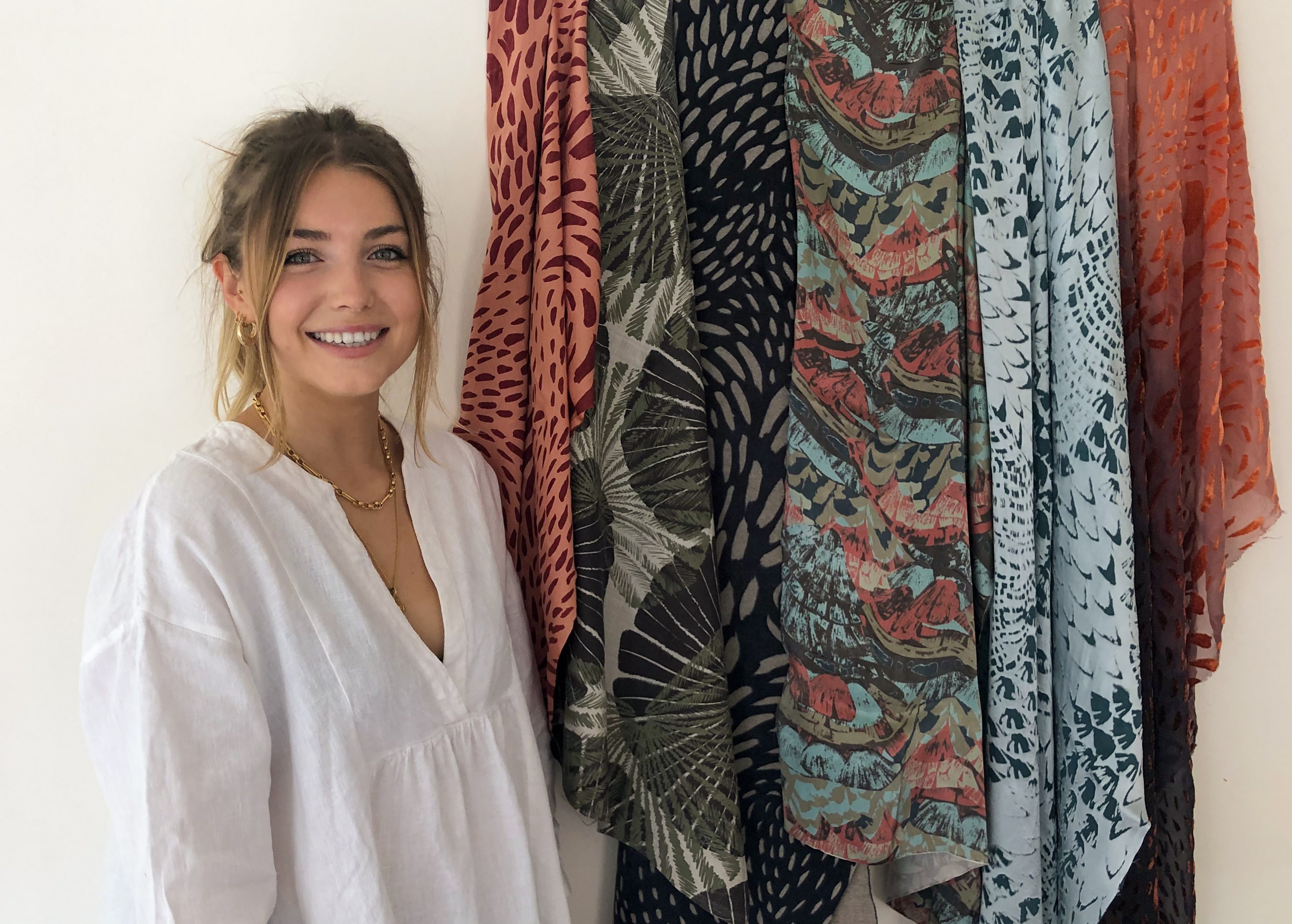 AUB BA (Hons) Textiles graduate L Kretowicz standing next to several textiles samples