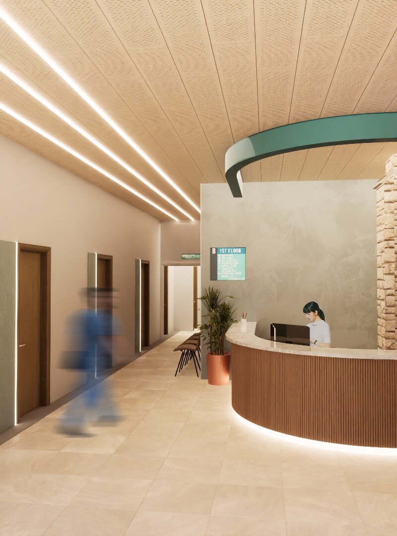 Modern reception area with curved wooden desk, arched green ceiling detail, LED strip lighting, and person walking past lift doors.
