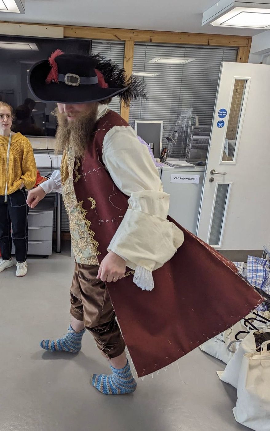 Red Captain Hook costume with a black feather hat worn by a model.