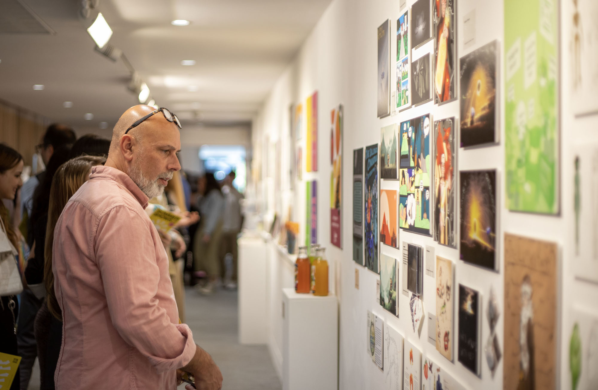 A man looks at an artwork display at TheGallery at the 2023 Foundation Summer Shows.