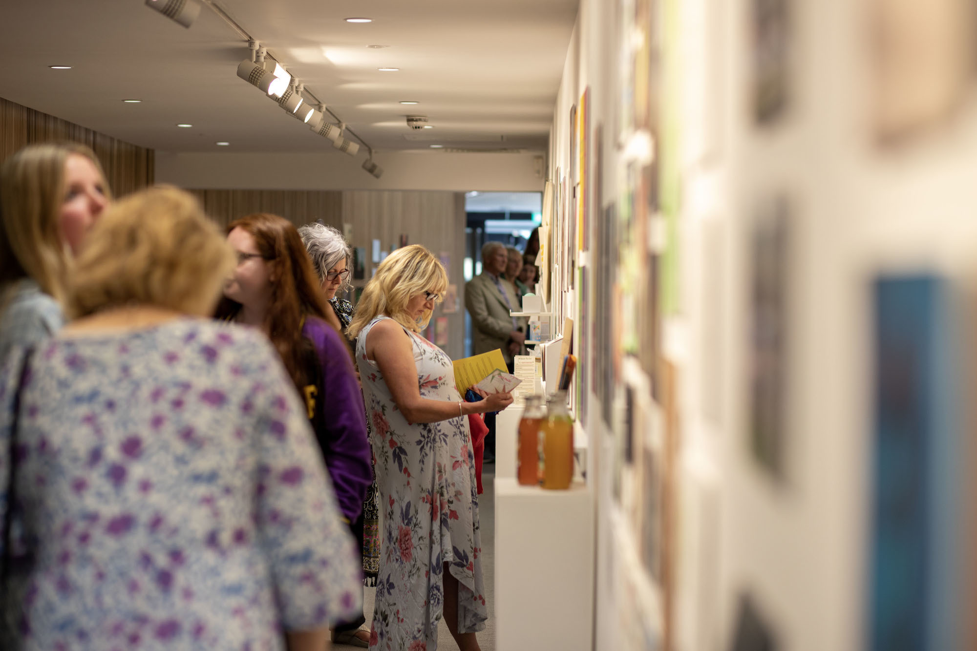 Several attendees of the 2023 Foundation Summer Show looking at exhibits.