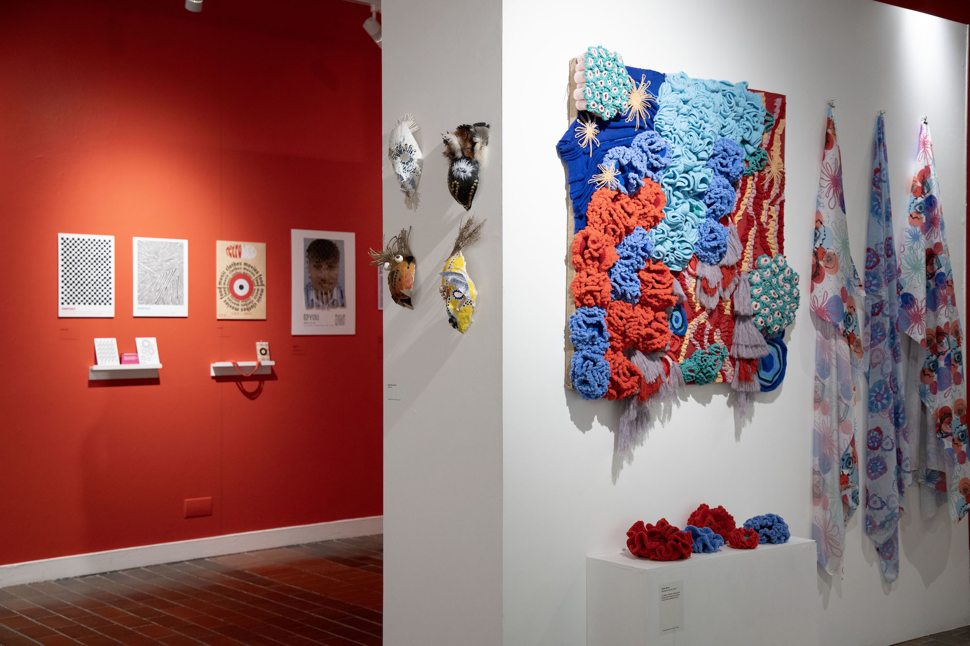Two walls of TheGallery with several abstract artworks and textiles on display.