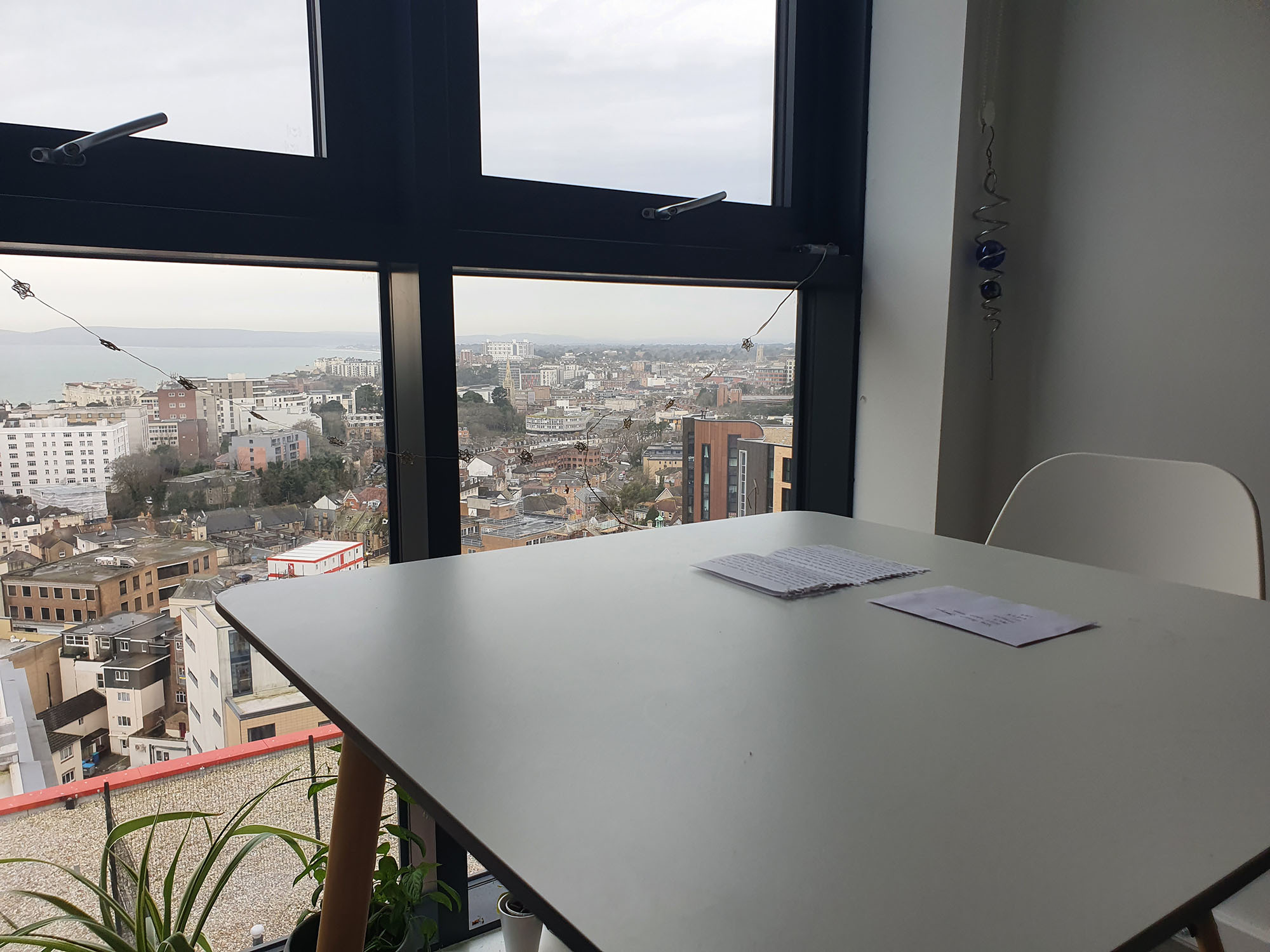 Image of a table with a city view from the window