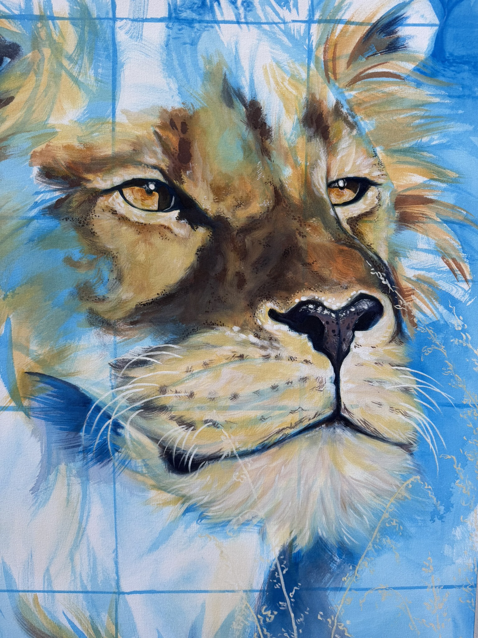 A close-up of a lion's face with detailed fur and prominent features. The background consists of blue tones, highlighting the lion's golden eyes and whiskers, showcasing intricate brushwork in a vibrant artistic style.