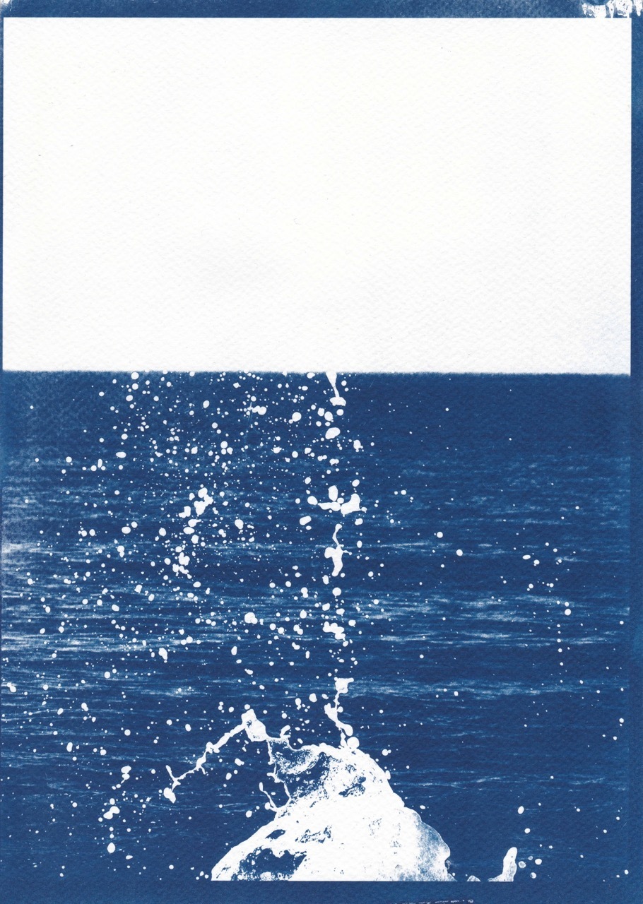 6.	A cyanotype of the sea, where a wave has crashed against a rock and thrown water into the air.