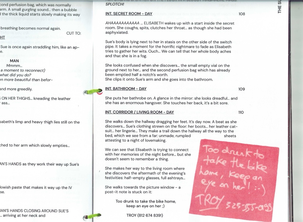 Screenplay pages with text in black typeface, pink sticky note with handwritten message in bottom right corner.