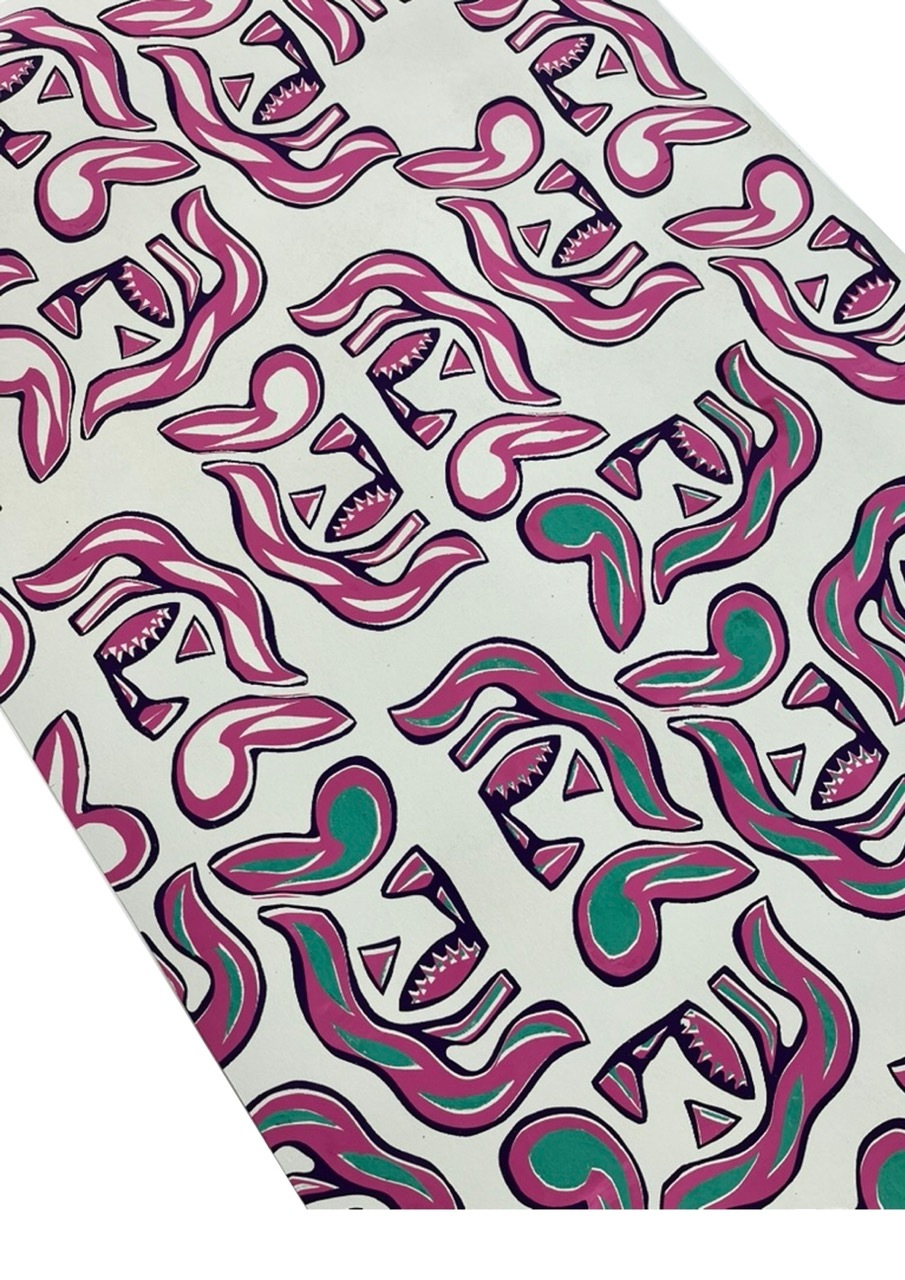 Repeating pattern of curved pink and purple tentacle-like shapes with triangular mouths showing teeth, scattered green circles on cream background.