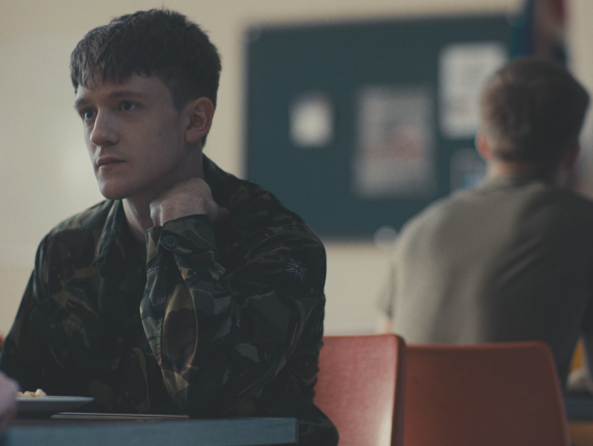 Still shot from Eyes, Front showing a character looking off-screen in a classroom-like setting.
