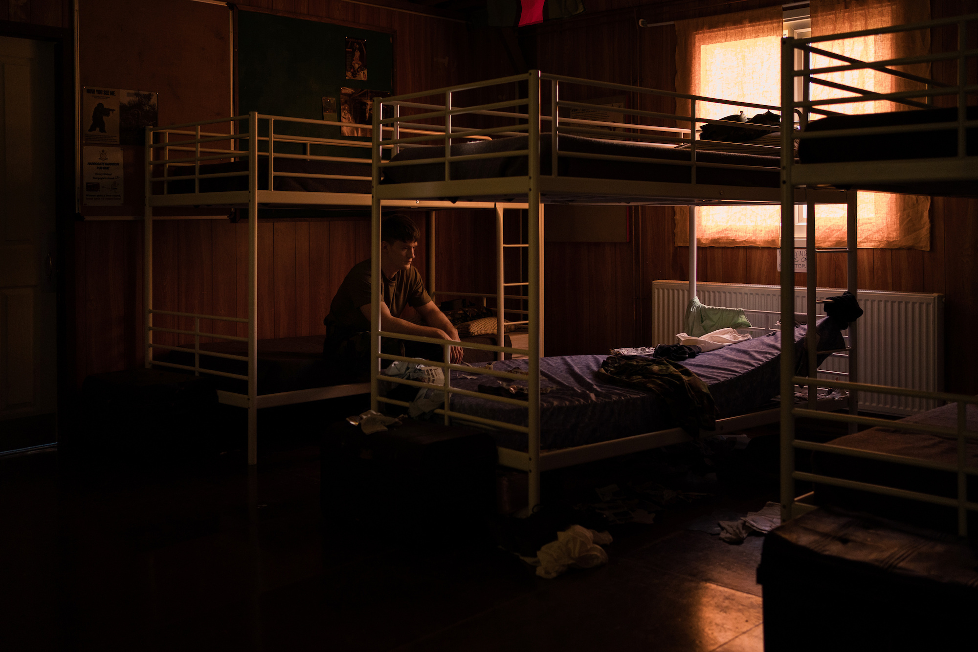 A BA (Hons) Acting student sitting on the end of a bunk bed in a scene from the film "Eyes, Front".