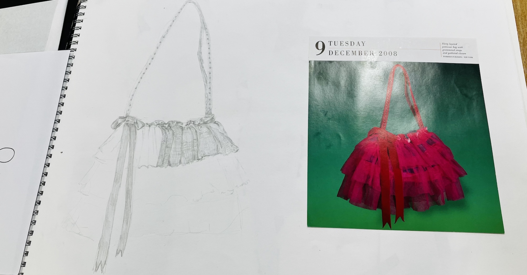 Pencil sketch of dress on spiral notebook beside colour reference image showing bright pink/red ruffled dress on green background