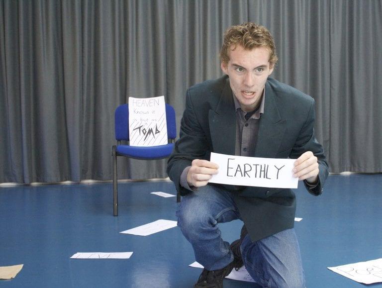 Man holding up earthly sign