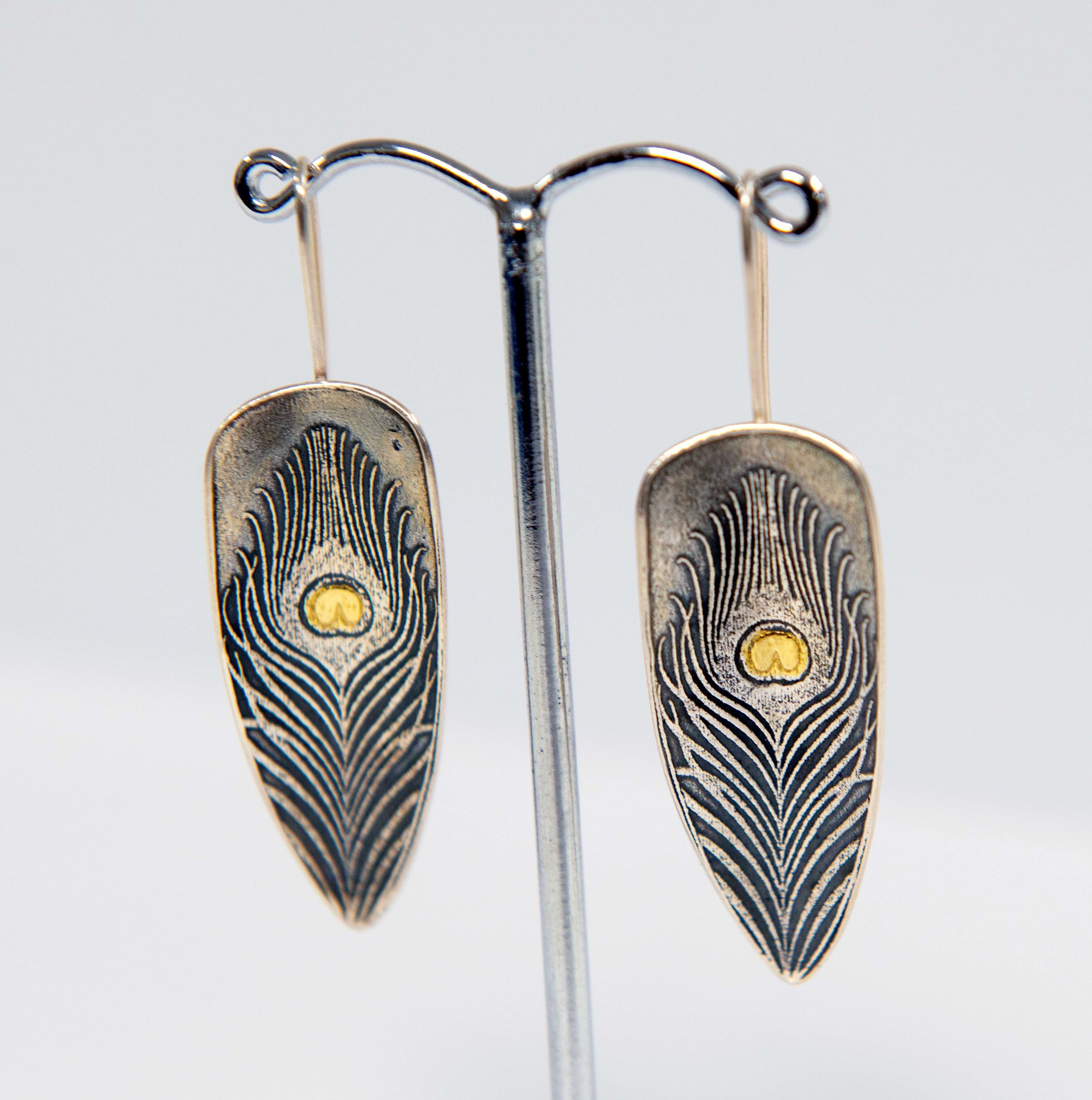 Silver earrings in shape of feathers
