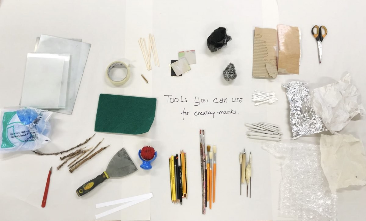Various tools used to create marks laid out on the table top