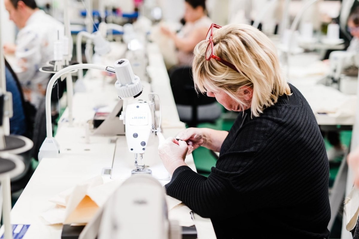 Image of a women setting up a sewing machine