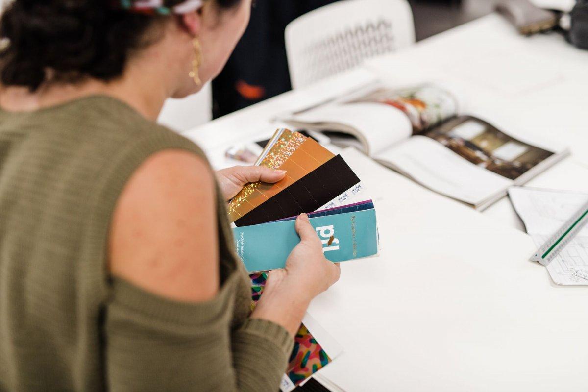 Student going through a swatch book of different materials