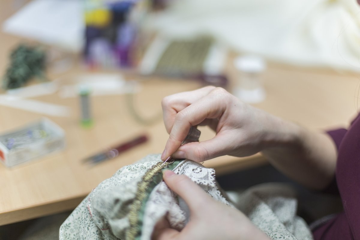 Close up of a hand sewing