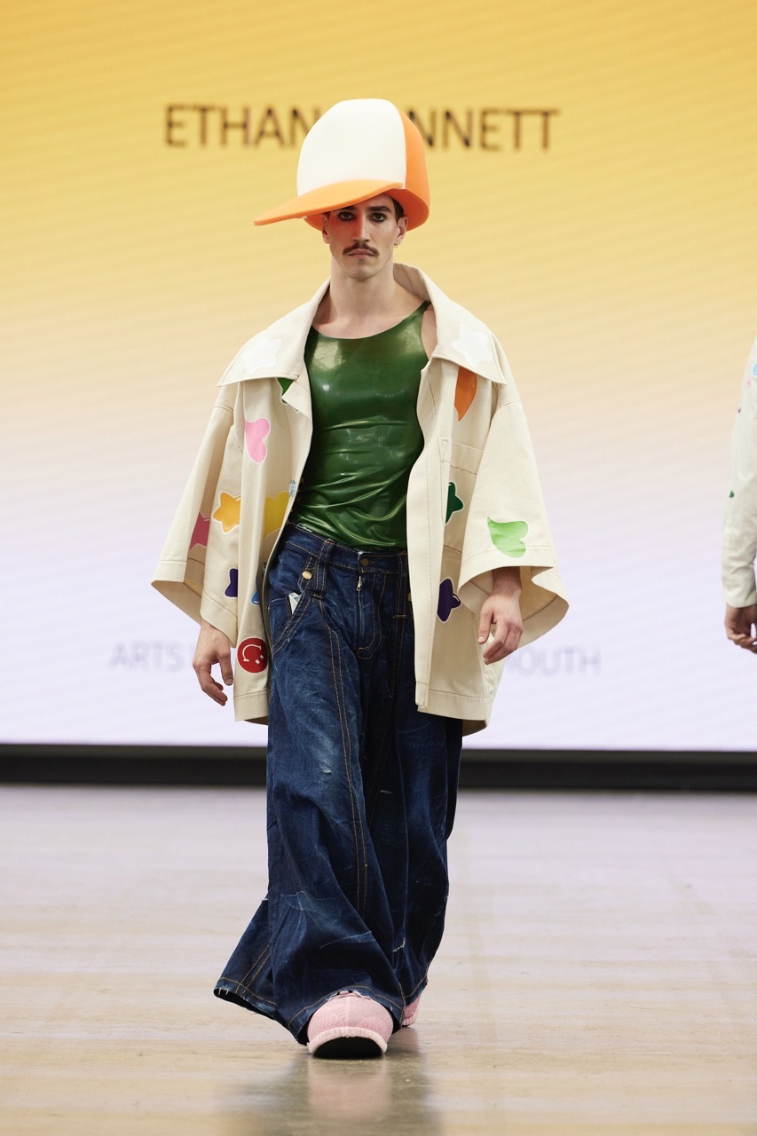A student model strutting down the catwalk for Graduate Fashion Week 2023