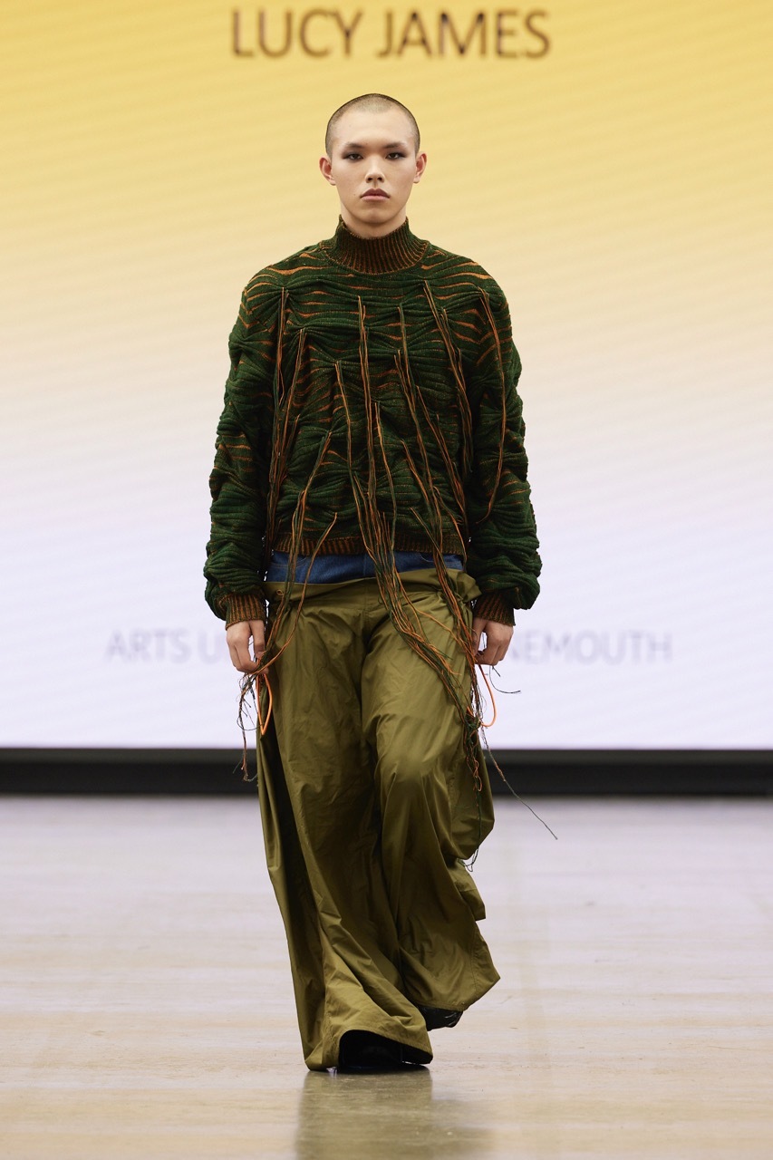A student model strutting down the catwalk for Graduate Fashion Week 2023
