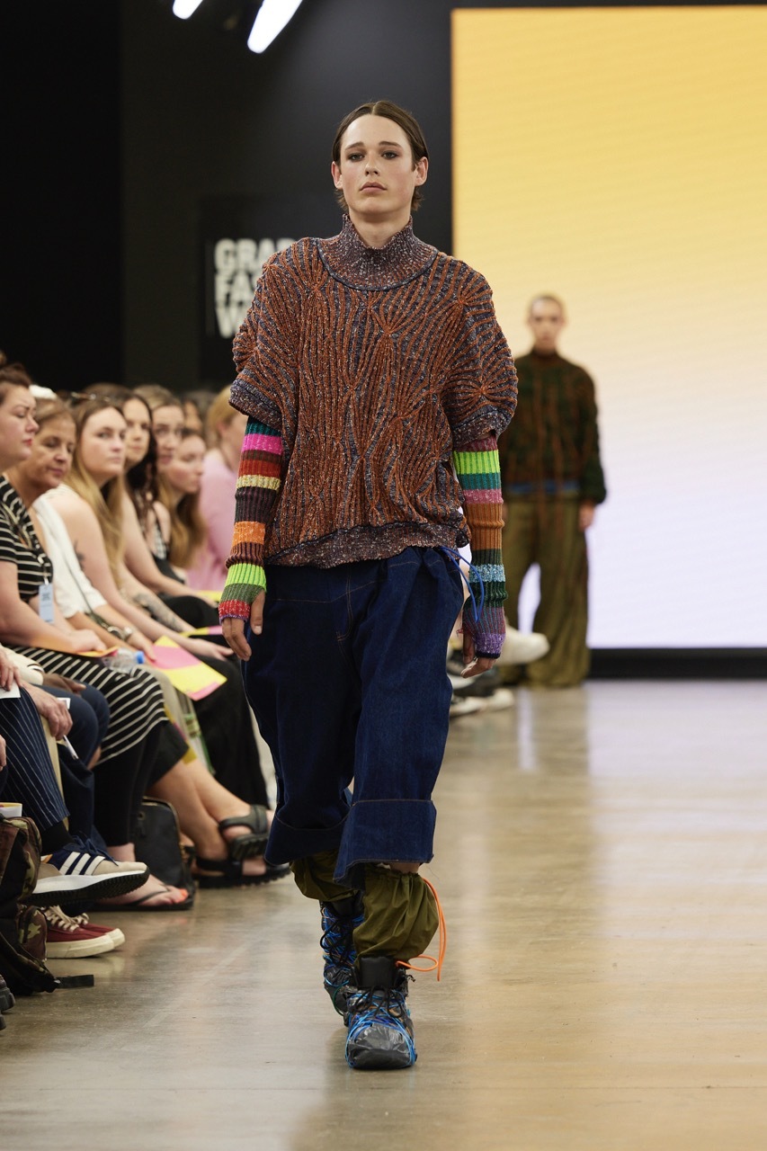 A student model strutting down the catwalk for Graduate Fashion Week 2023