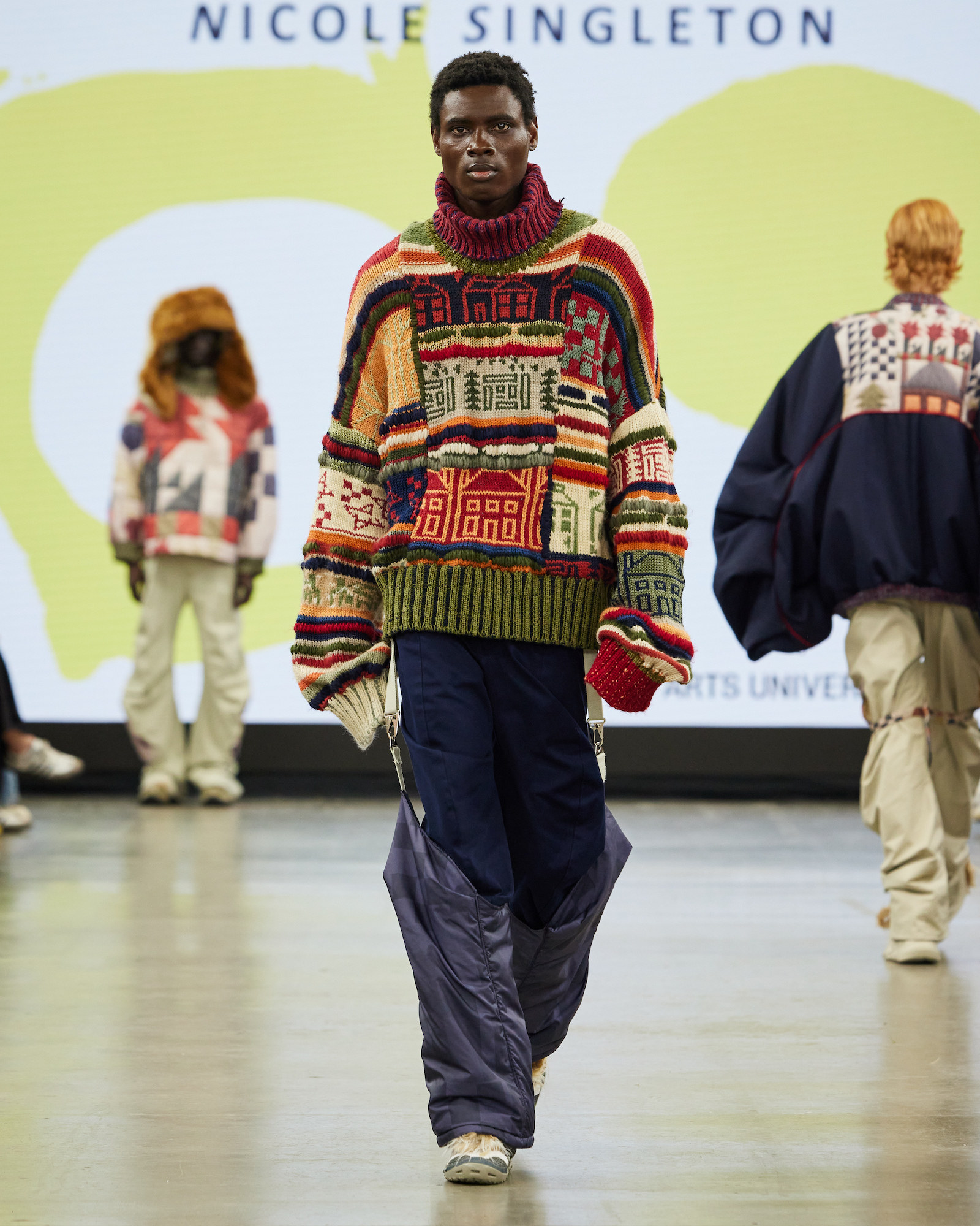 A model walking down the catwalk at Graduate Fashion Week 2024 wearing a creation by BA (Hons) Fashion student N Singleton.