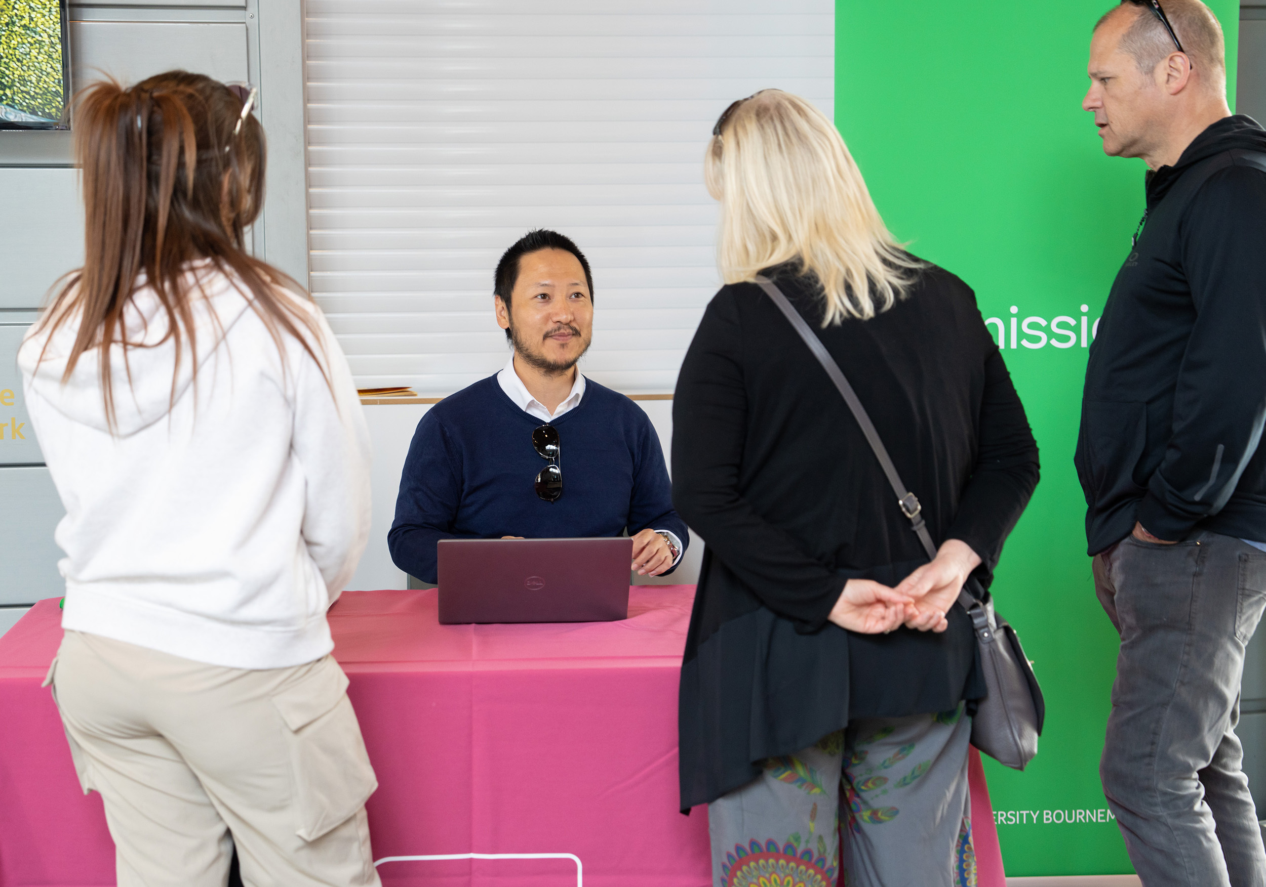 Member of the Admissions talking to prospective students at an Open Day