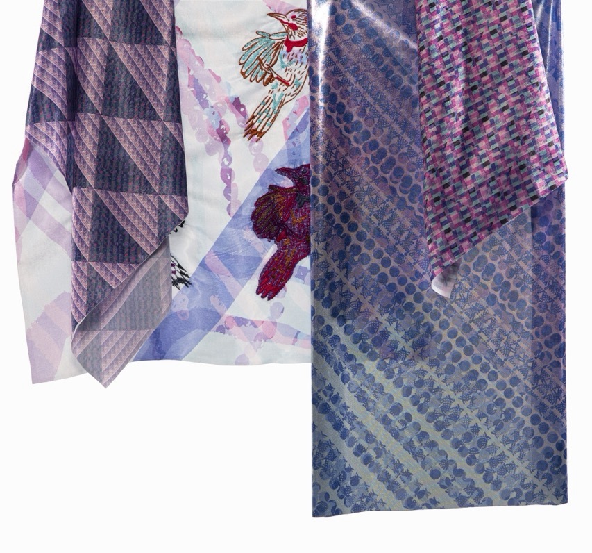 Four overlapping silk ties displaying diagonal patterns in purple, grey, and pink tones with geometric designs and small motifs.